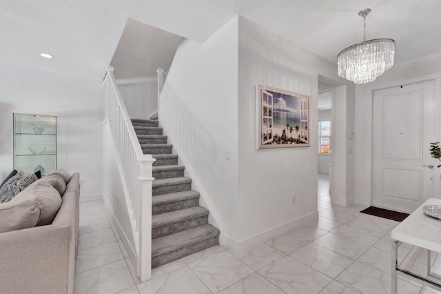 entrance foyer featuring a chandelier and a textured ceiling