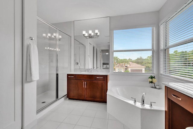 bathroom featuring tile patterned floors, plenty of natural light, shower with separate bathtub, and vanity