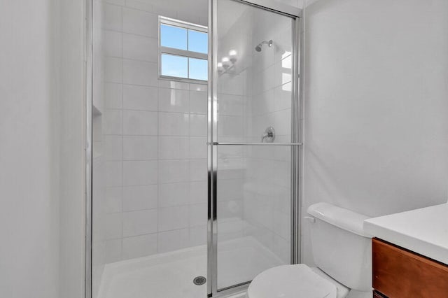 bathroom with an enclosed shower and toilet