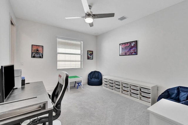 carpeted office featuring ceiling fan