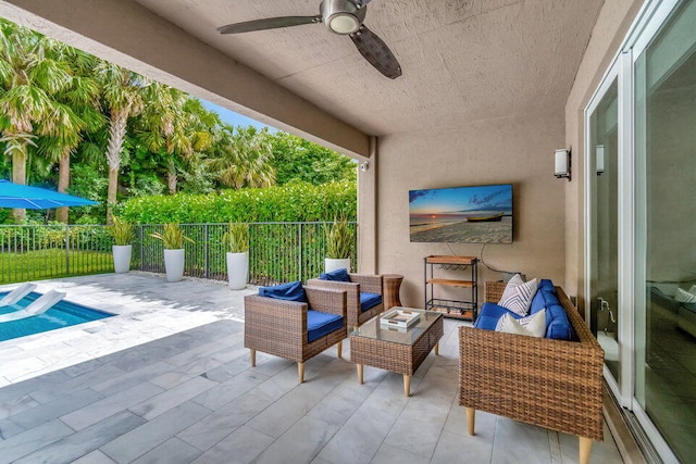 view of patio / terrace with ceiling fan and a swimming pool