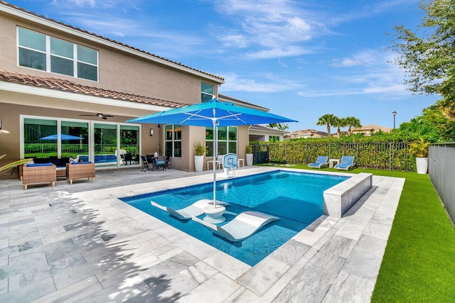 view of pool featuring outdoor lounge area, a patio, and ceiling fan