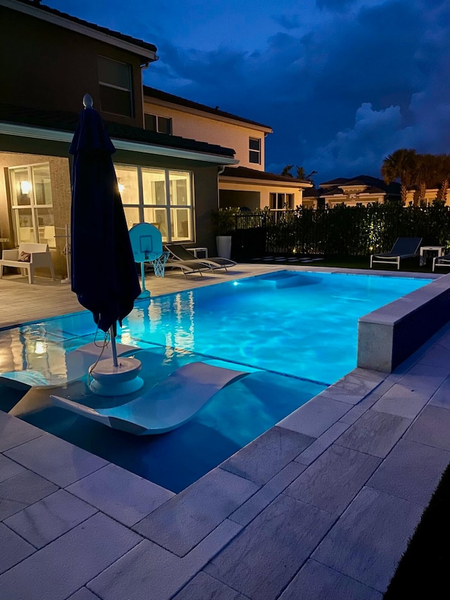 view of swimming pool with a patio