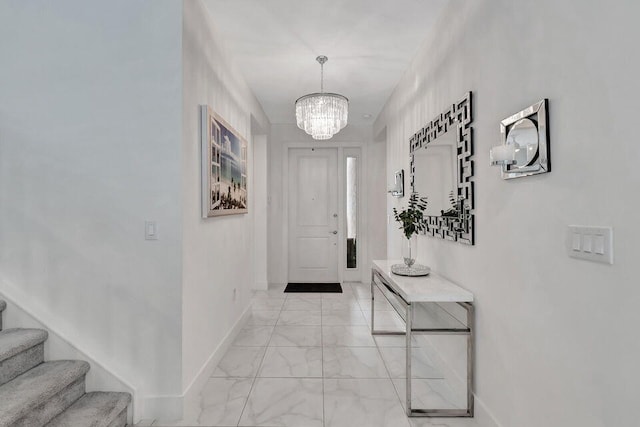 entryway with a chandelier