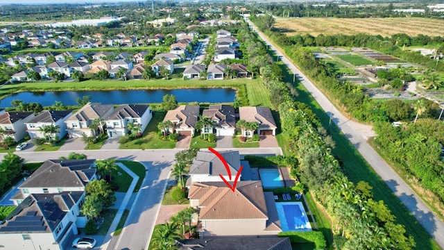 birds eye view of property with a water view