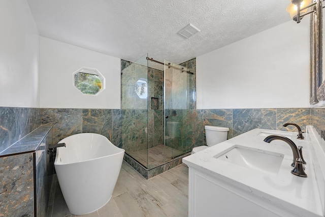 bathroom featuring a textured ceiling and tiled shower