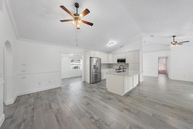 unfurnished room with crown molding, light hardwood / wood-style floors, lofted ceiling, and a notable chandelier