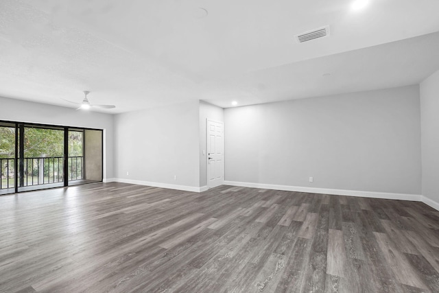 empty room featuring ceiling fan and dark hardwood / wood-style floors