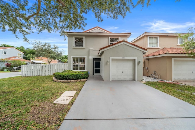 mediterranean / spanish-style home with a garage and a front yard