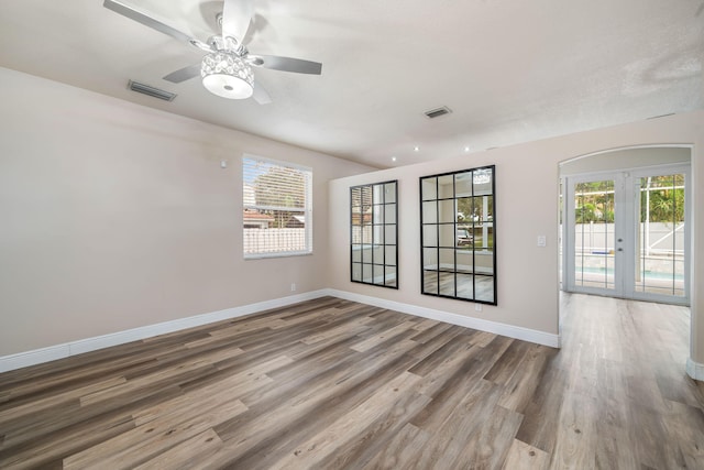 spare room featuring hardwood / wood-style floors, french doors, and ceiling fan