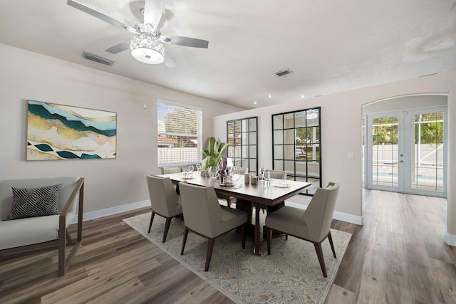 dining area with ceiling fan, wood-type flooring, and french doors