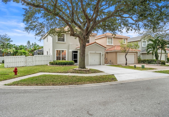 mediterranean / spanish home featuring a front lawn and a garage