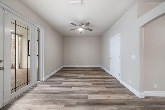 spare room featuring ceiling fan, plenty of natural light, and light hardwood / wood-style flooring