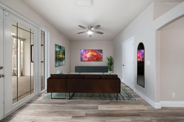 living room with ceiling fan and light hardwood / wood-style floors