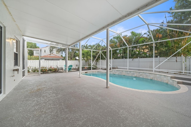 view of swimming pool with a lanai and a patio