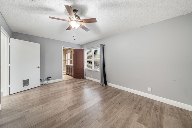 unfurnished bedroom with ensuite bath, ceiling fan, a textured ceiling, and light wood-type flooring