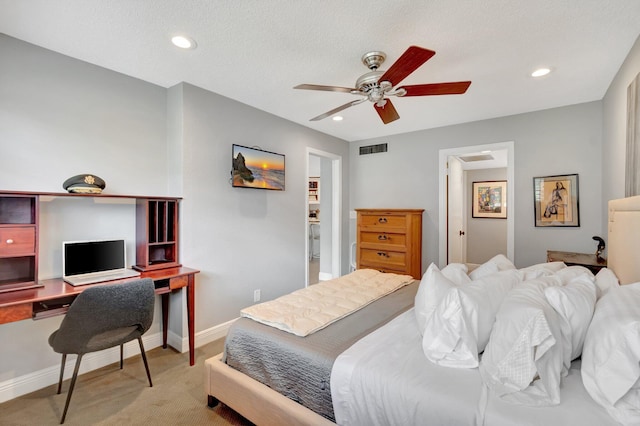 bedroom featuring light carpet, a textured ceiling, and ceiling fan