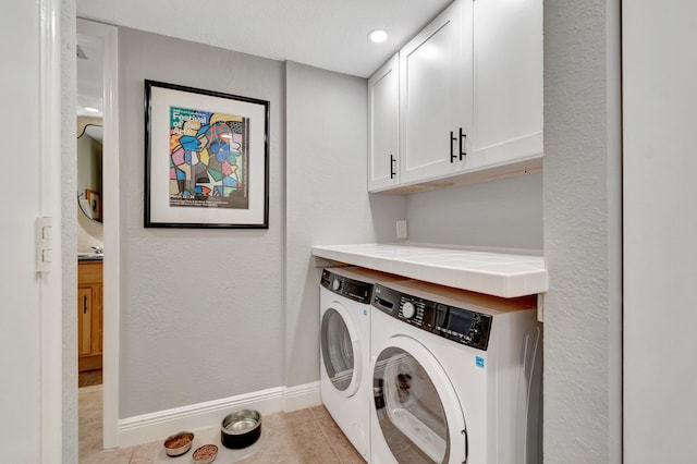 washroom with light tile patterned flooring, cabinets, and independent washer and dryer