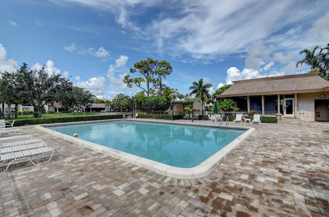 view of swimming pool featuring a patio area and an outdoor structure