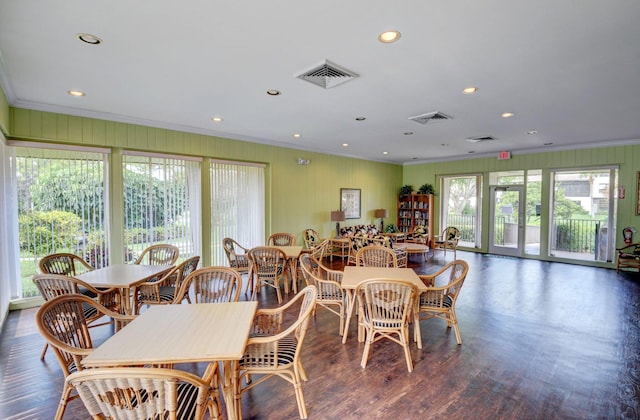 dining space with dark hardwood / wood-style flooring, plenty of natural light, and ornamental molding