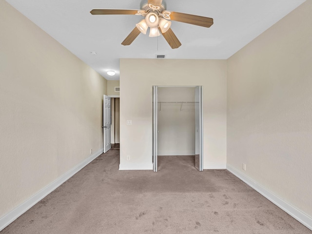 unfurnished bedroom with ceiling fan, a closet, and light colored carpet