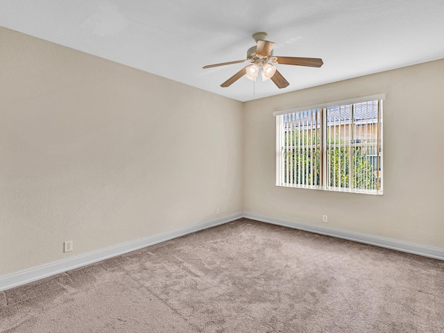 carpeted spare room with ceiling fan