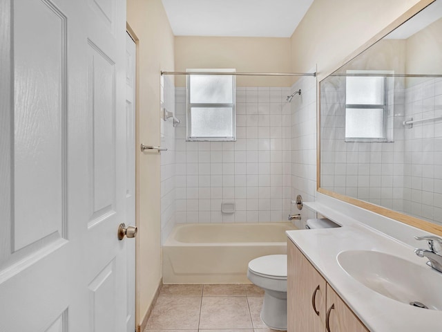 full bathroom featuring toilet, vanity, tile patterned floors, and a healthy amount of sunlight