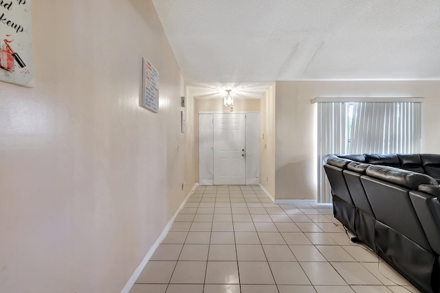 foyer featuring a textured ceiling and light tile patterned floors