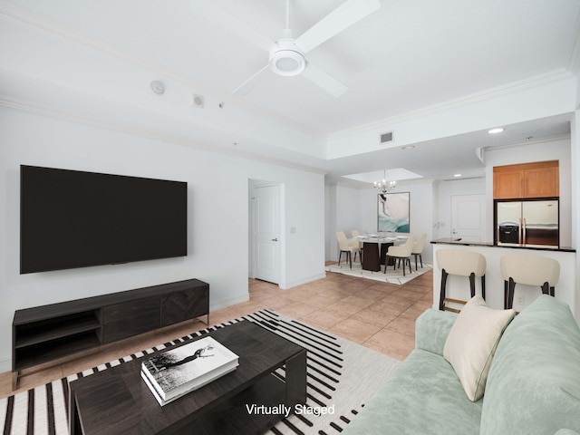 tiled living room with ornamental molding and ceiling fan with notable chandelier