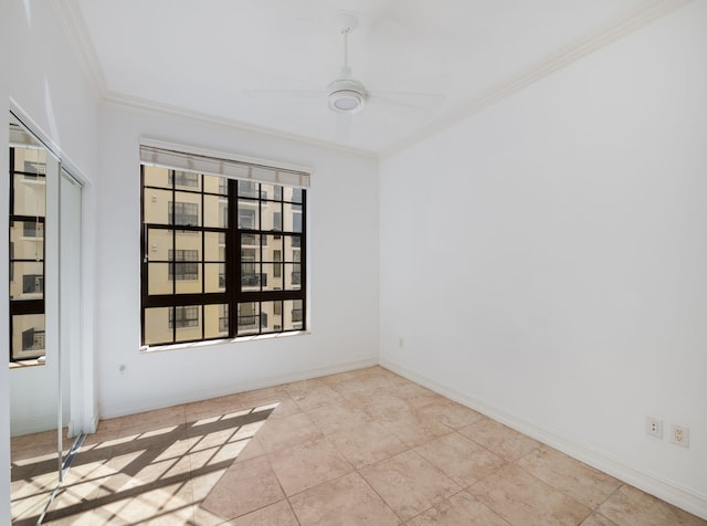 spare room featuring ceiling fan and ornamental molding