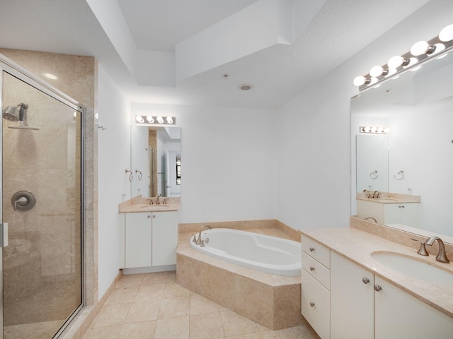 bathroom featuring tile patterned flooring, vanity, and separate shower and tub