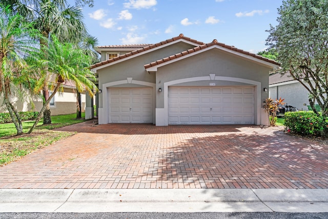 mediterranean / spanish home featuring a garage