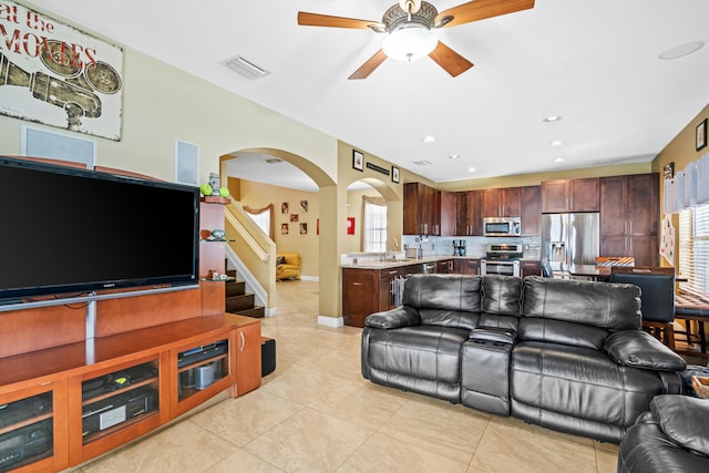 tiled living room featuring ceiling fan