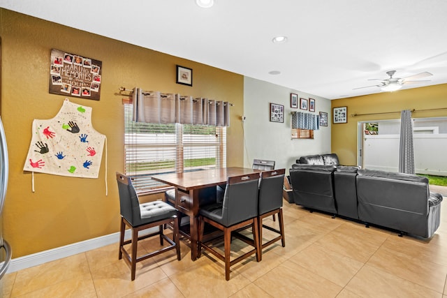 dining space featuring ceiling fan and light tile patterned floors