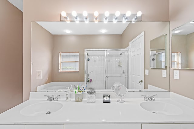 bathroom with vanity and independent shower and bath