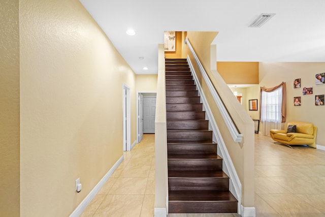 stairs featuring tile patterned flooring