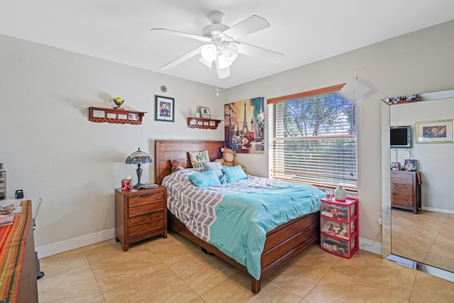 tiled bedroom featuring ceiling fan