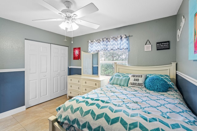 bedroom featuring a closet, light tile patterned floors, and ceiling fan