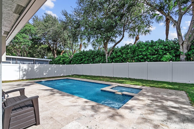 view of swimming pool with an in ground hot tub and a patio area