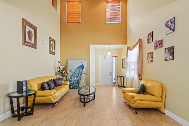 living room with a high ceiling and light tile patterned flooring