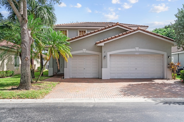 mediterranean / spanish house with a garage