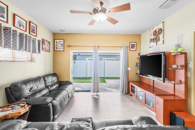 living room featuring light tile patterned floors, ceiling fan, and plenty of natural light