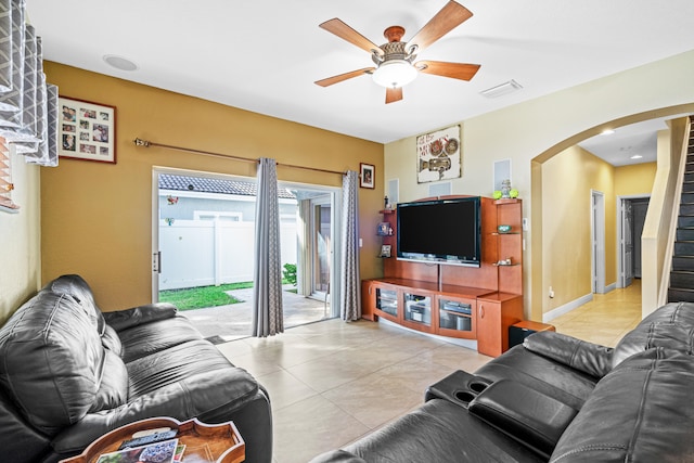 tiled living room with ceiling fan