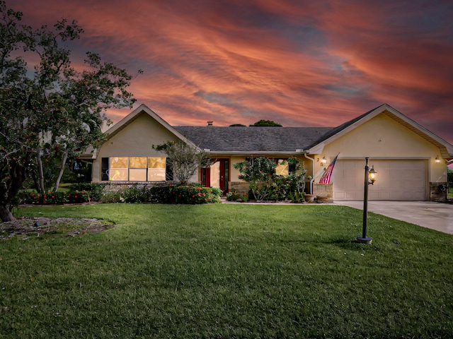 single story home with a yard and a garage