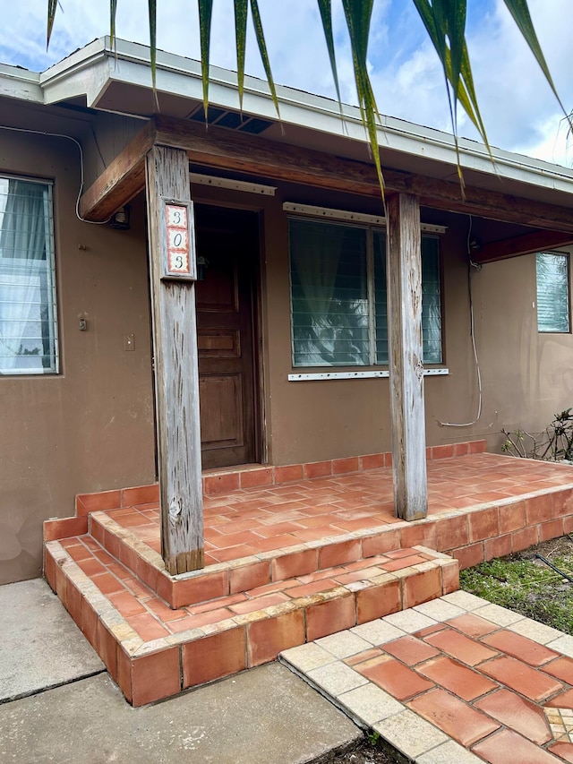 view of exterior entry featuring a porch