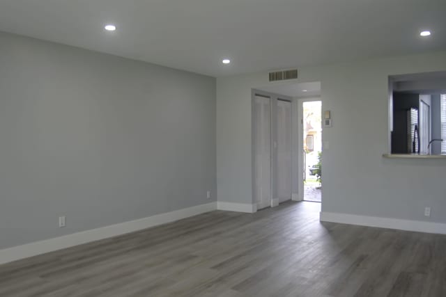 spare room with dark hardwood / wood-style flooring