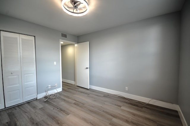 unfurnished bedroom featuring light hardwood / wood-style floors and a closet