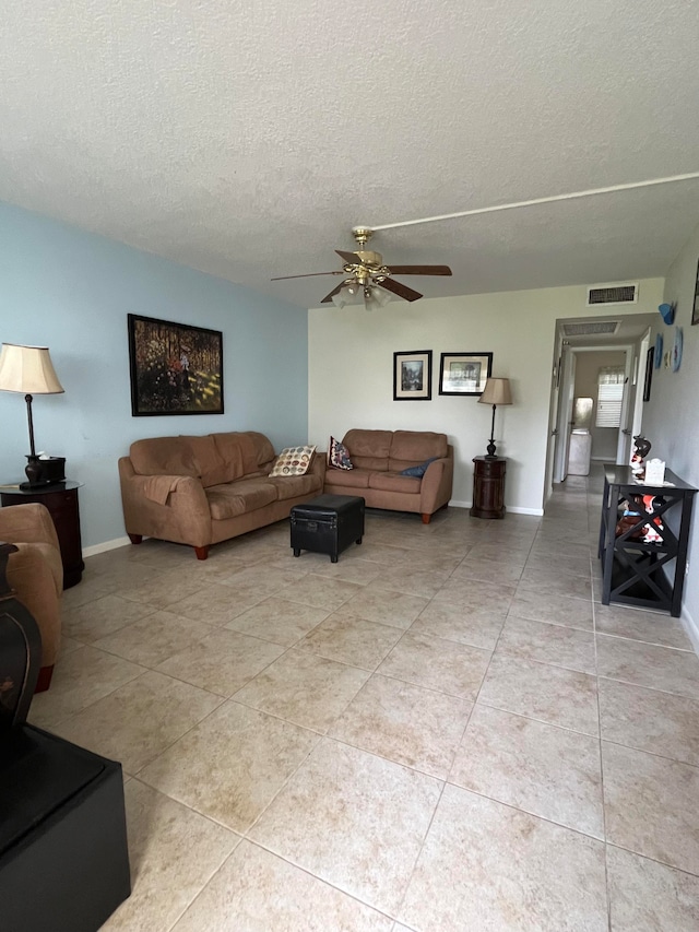 living room featuring tile walls and ceiling fan