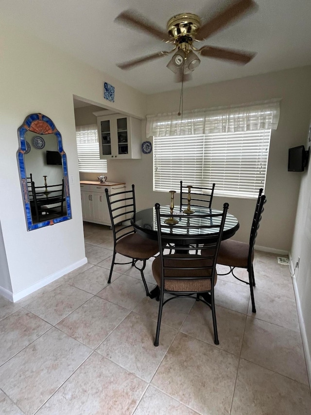 dining room with light tile patterned floors and ceiling fan