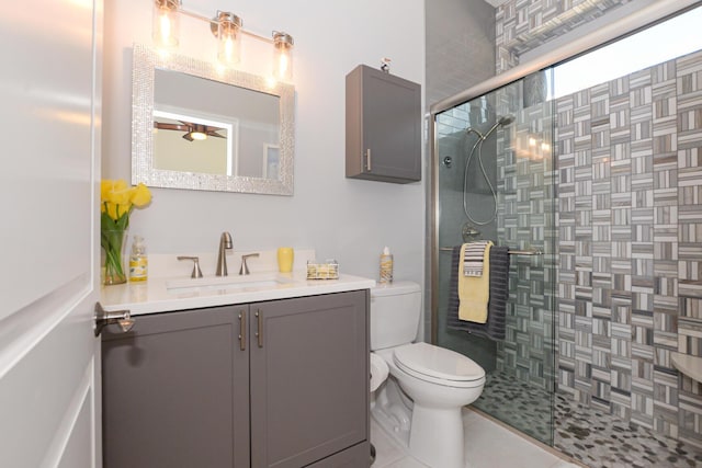 bathroom with vanity, tile patterned flooring, toilet, and a shower with shower door